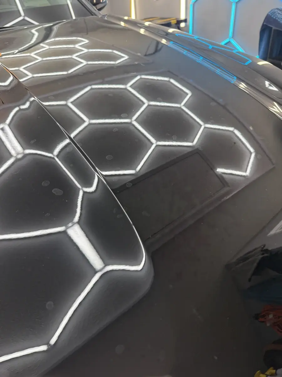Water spots and dust on the black hood of a 2023 Toyota Highlander before a full detail in Panama City FL