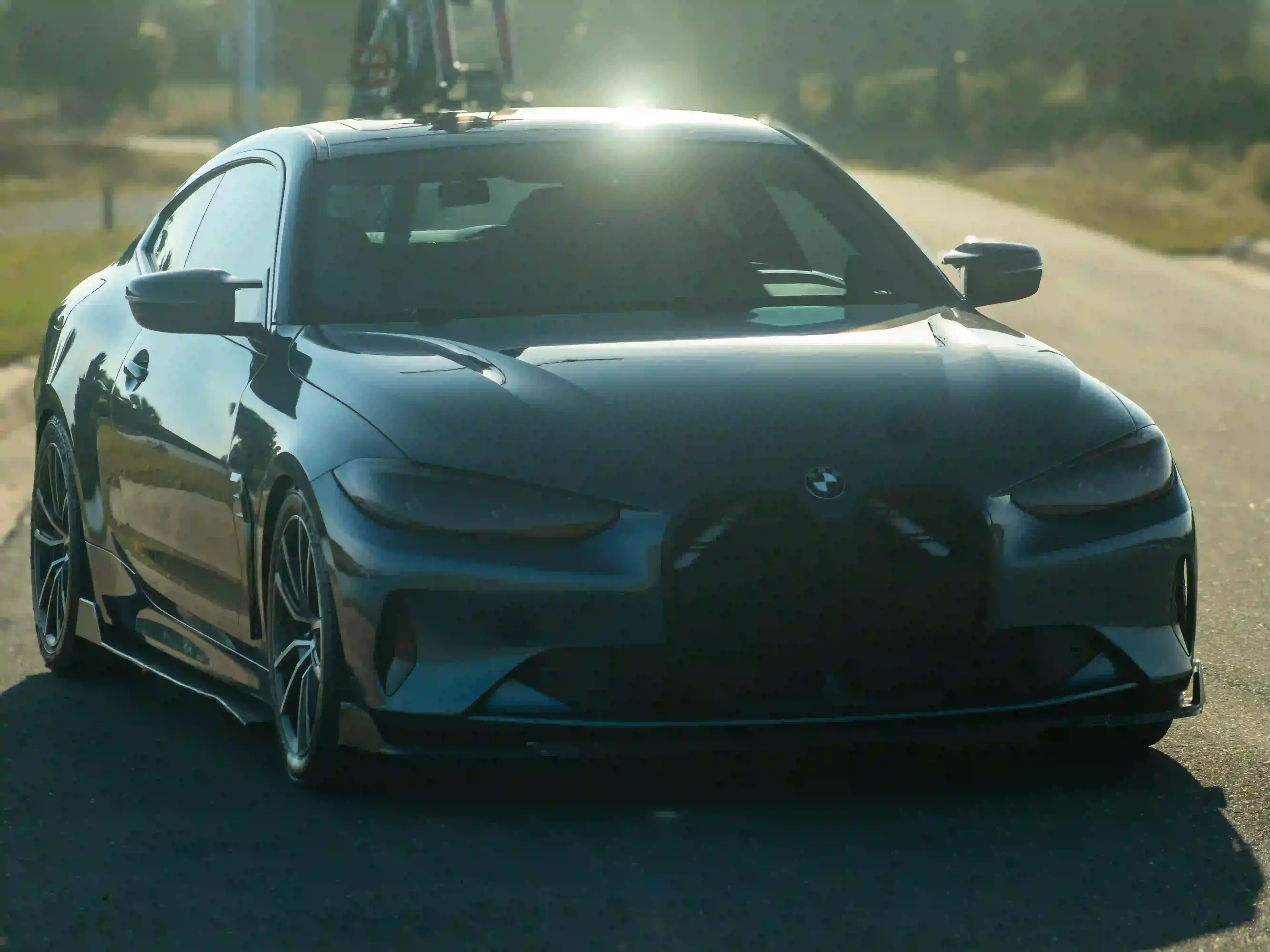 BMW M4 front end in morning sunlight after full ceramic coating service