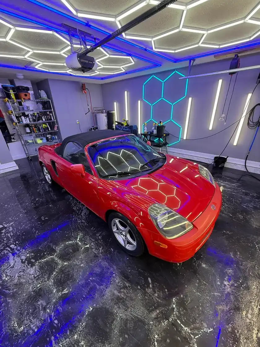 Red 2001 Toyota MR2 Spyder convertible after a full detail under the hex lights at Ceramico in Panama City FL