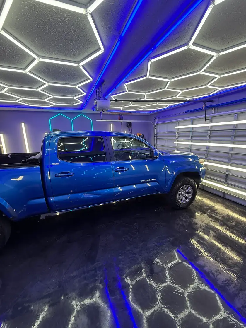 Blue 2017 Toyota Tacoma after a full interior and exterior detail under the hex lights at Ceramico in Panama City FL