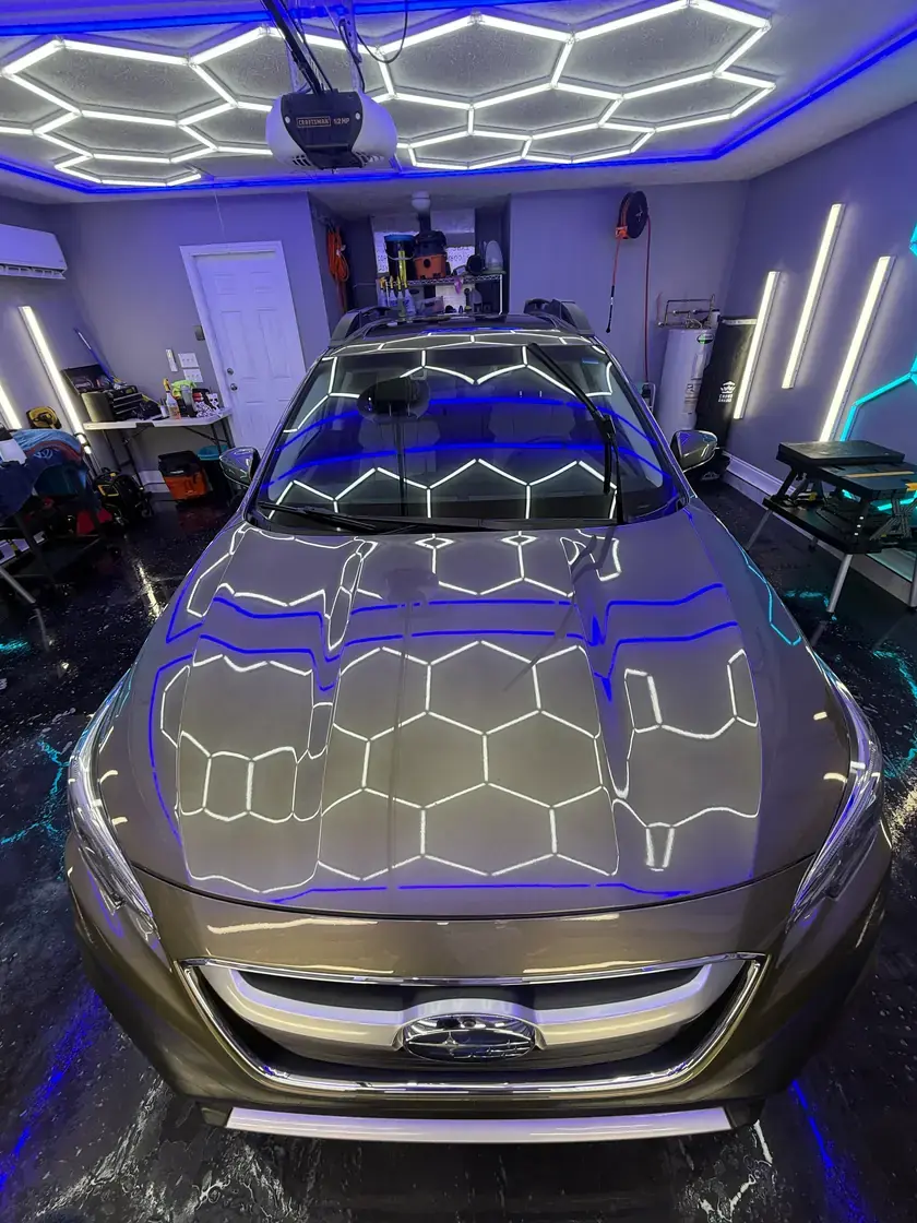 Green 2022 Subaru Outback with the hex lights reflected in the hood after a full detail at Ceramico in Panama City FL