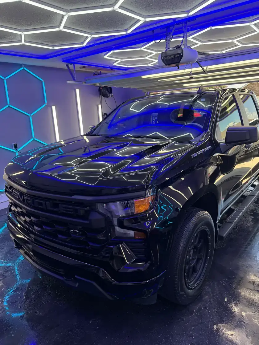 Black 2023 Chevy Silverado after a full interior and exterior detail under the hex lights at Ceramico in Panama City FL