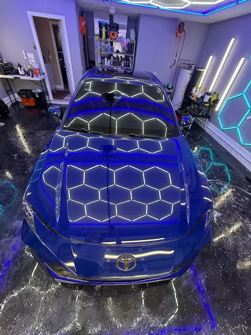 Dark blue 2024 Toyota Camry after a full interior and exterior detail under the hex lights at Ceramico in Panama City FL