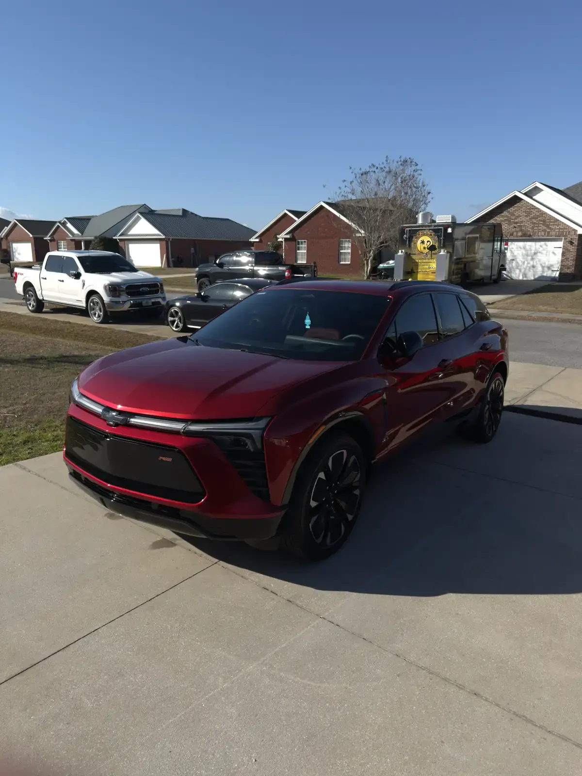 Ceramic coated red 2024 Chevy Blazer EV in the Florida sun in a Panama City driveway