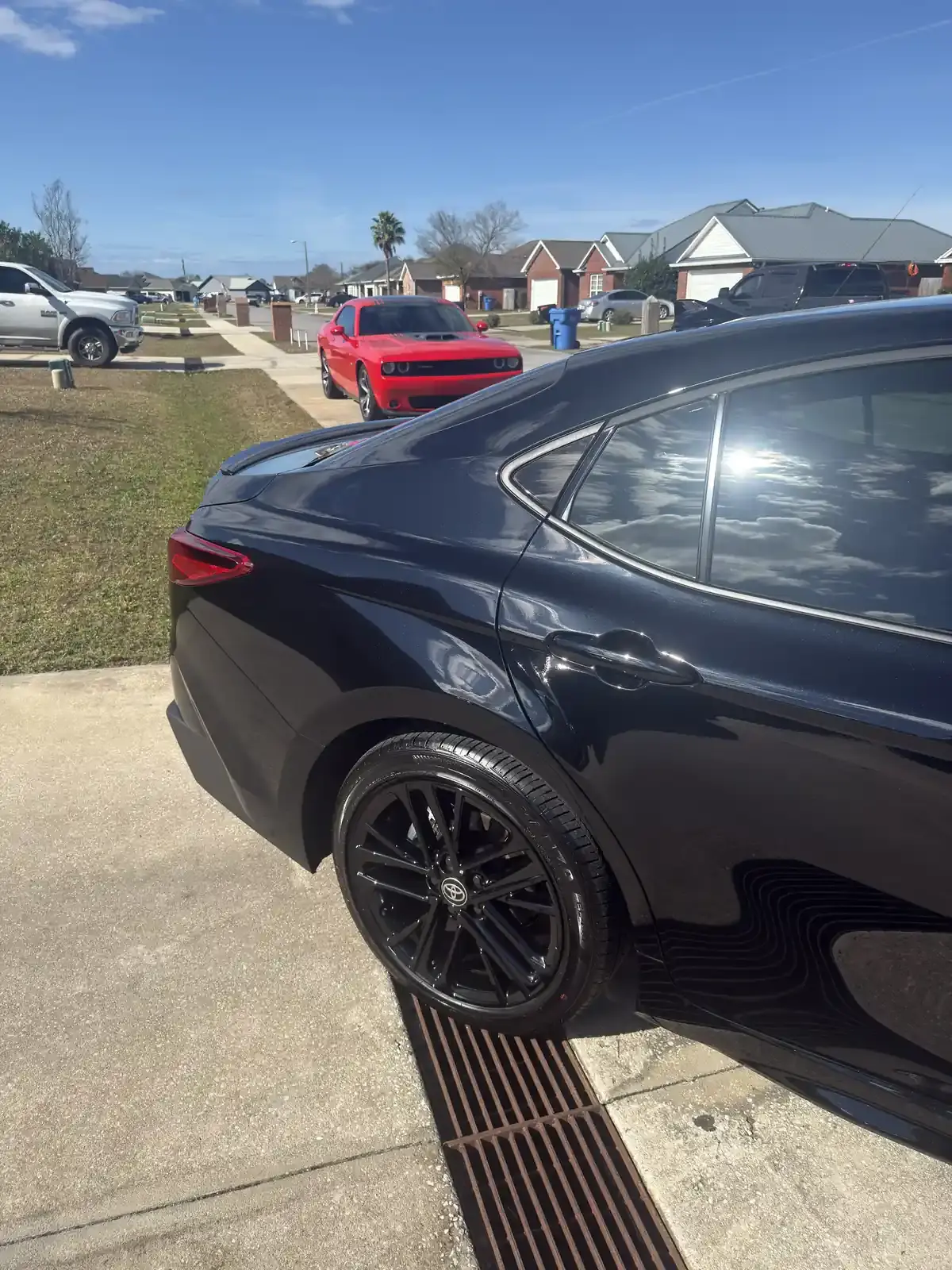 Rear three-quarter view of a ceramic coated 2026 Toyota Camry showing deep gloss on the dark blue paint