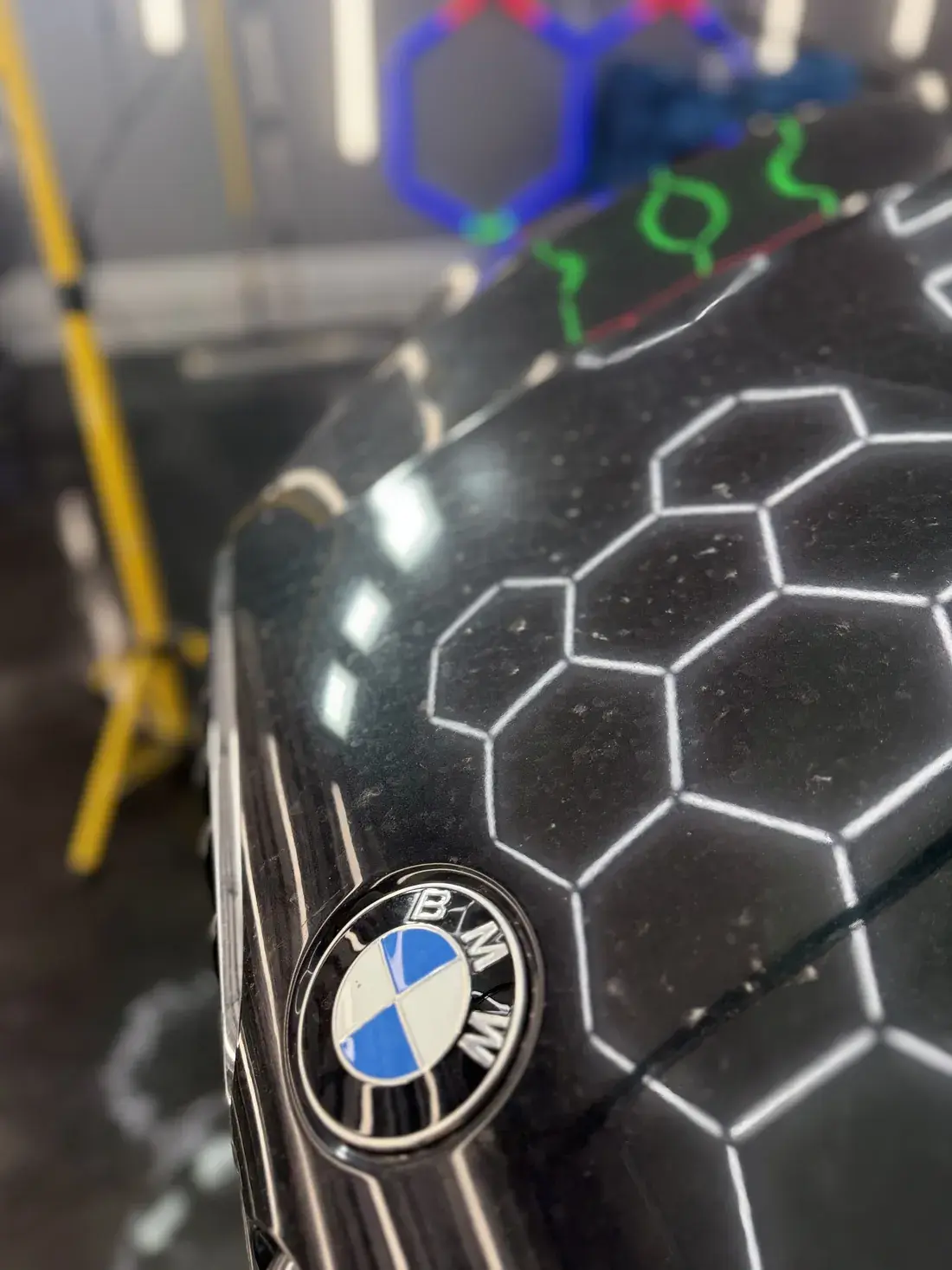 Hood, at the badge before paint correction in Panama City FL