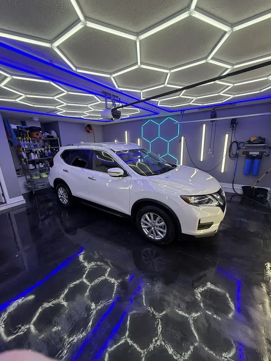 White 2020 Nissan Rogue under the hex shop lights after a full detail in Panama City FL
