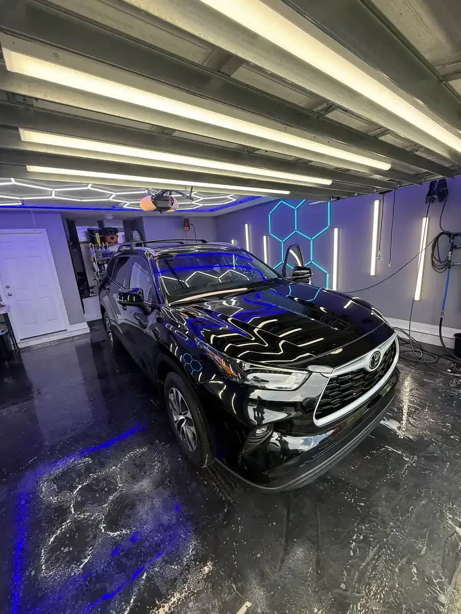 Black 2023 Toyota Highlander under the hex shop lights after a full detail in Panama City FL
