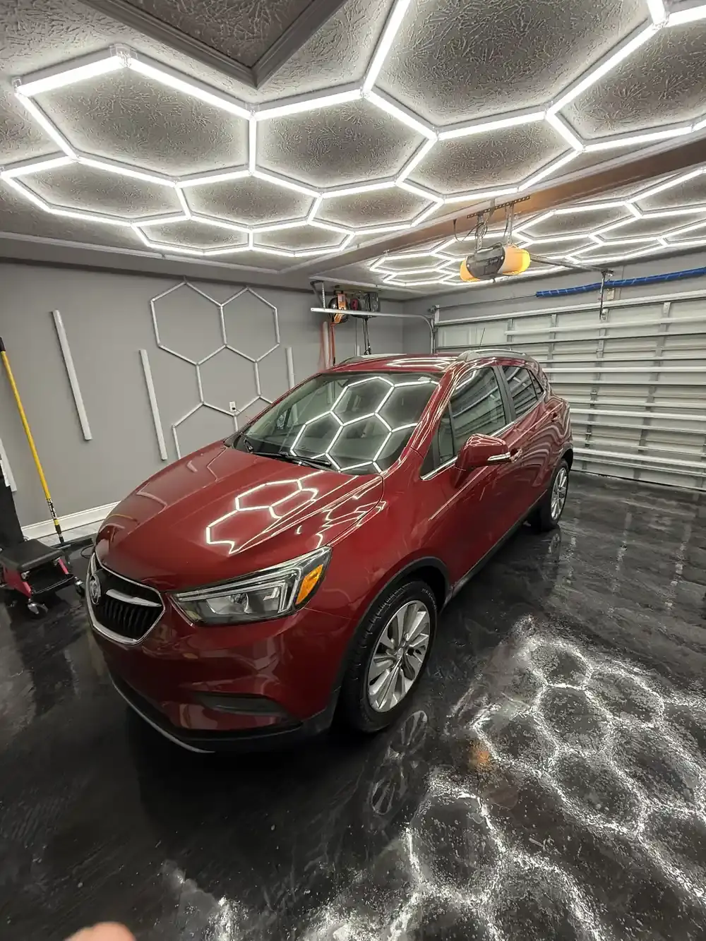 Red 2019 Buick Encore after a full interior and exterior detail under the hex shop lights in Panama City FL