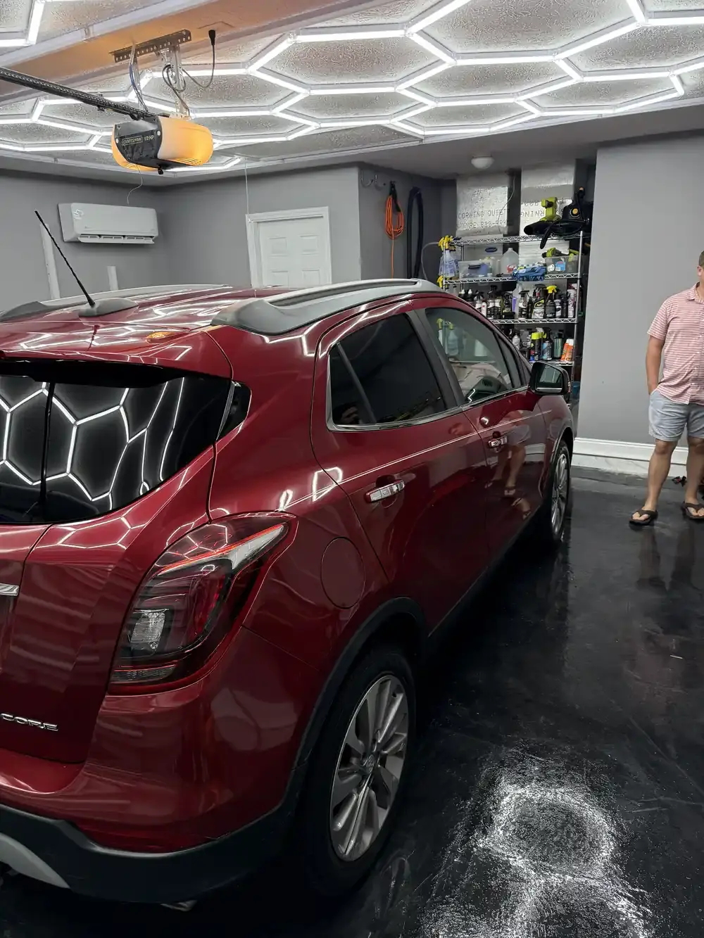 Rear three-quarter view of a red 2019 Buick Encore after a full detail in the shop in Panama City FL