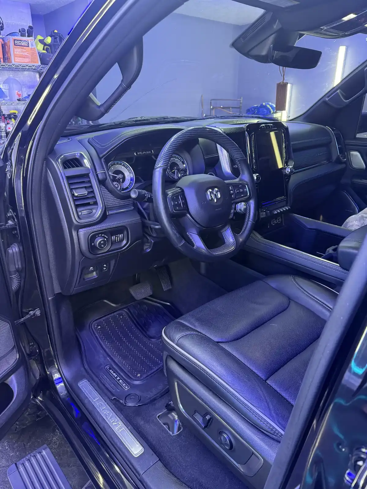 Clean black leather interior and steering wheel of a 2018 Dodge Ram after an interior detail in Panama City FL