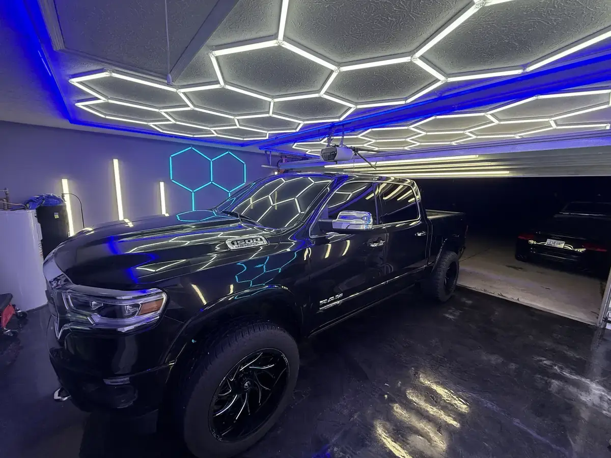 Black 2018 Dodge Ram with black wheels after a full interior and exterior detail under the shop lights in Panama City FL