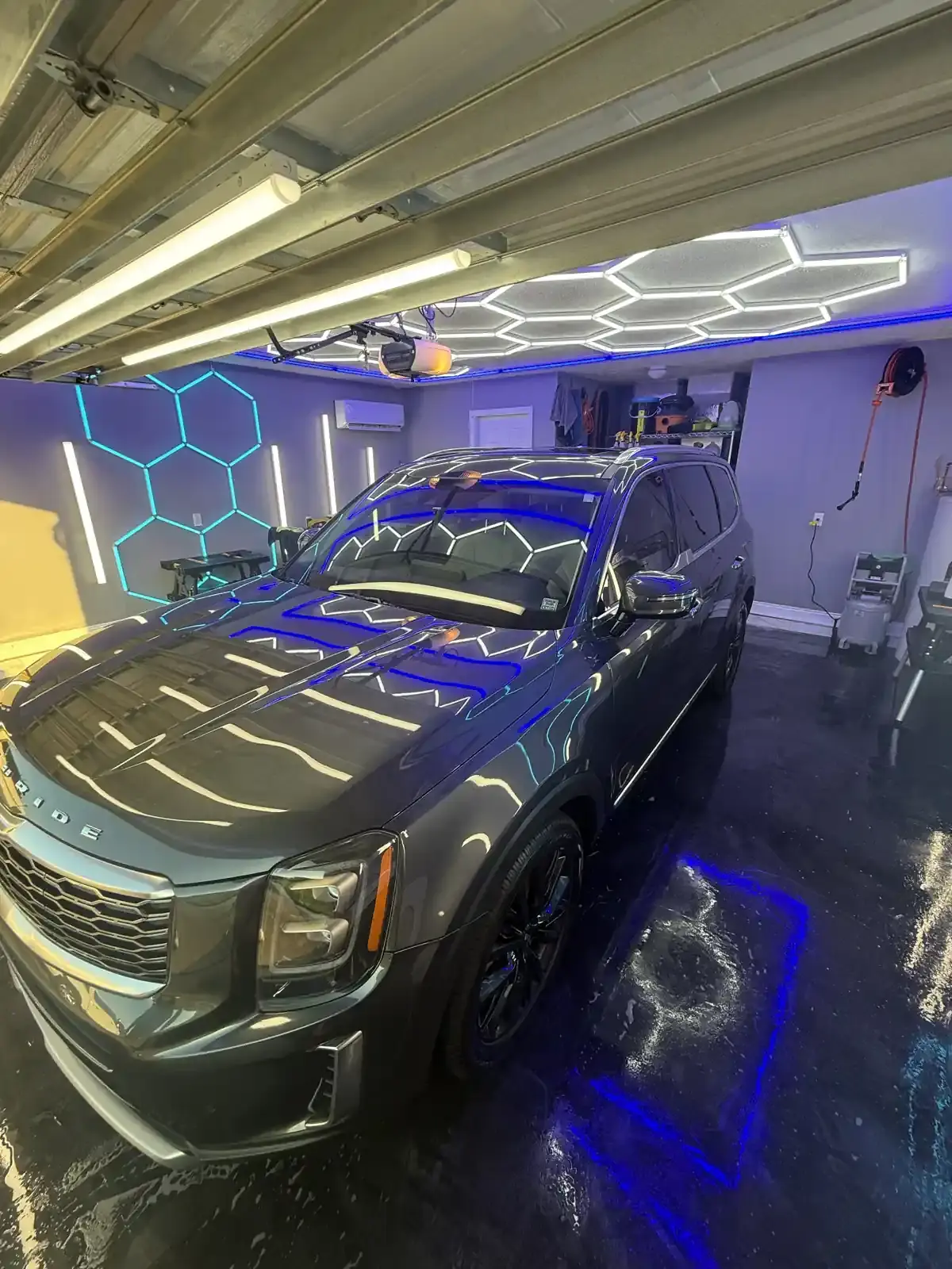 Grey 2021 Kia Telluride under the hex shop lights after a full detail in Panama City FL