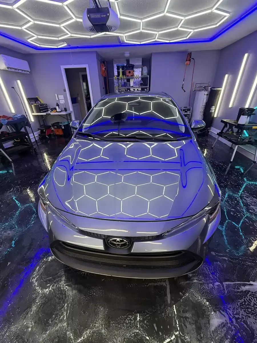 Silver grey Toyota Corolla under the hex shop lights after a full detail in Panama City FL