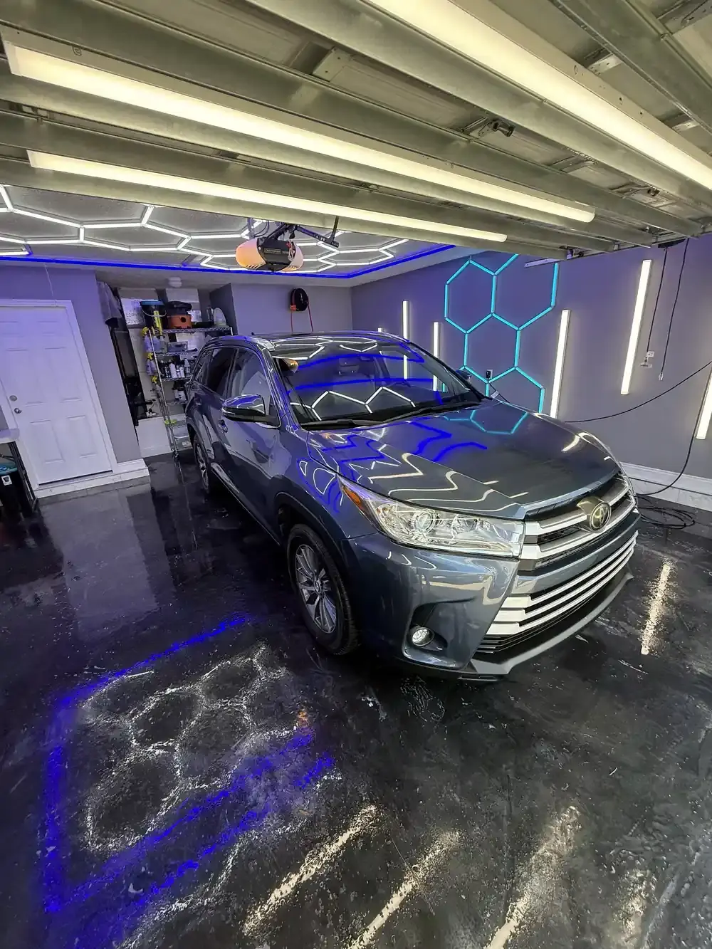 Blue grey 2017 Toyota Highlander under the hex shop lights after a full detail in Panama City FL