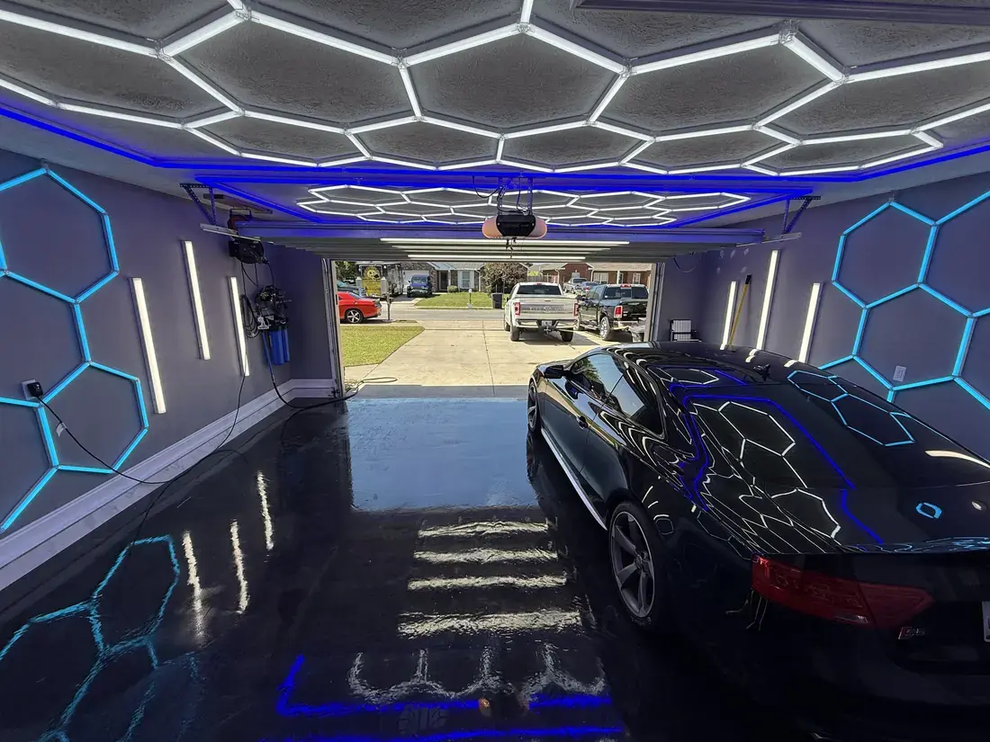 Inside the Ceramico garage in Panama City FL, hex LED lighting and epoxy floors with the door open to the street