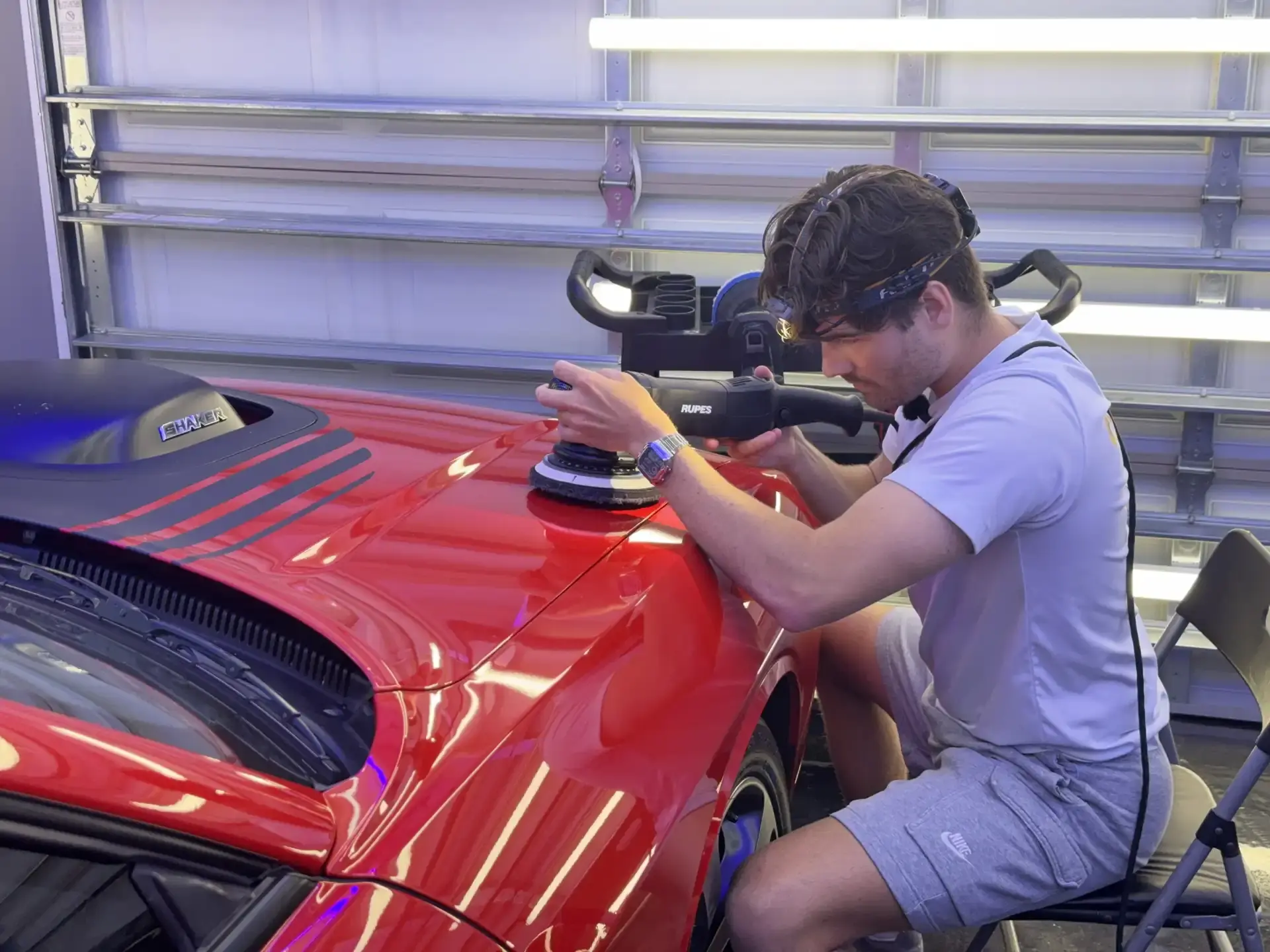 paint correction being performed on red Mustang in Panama City FL garage