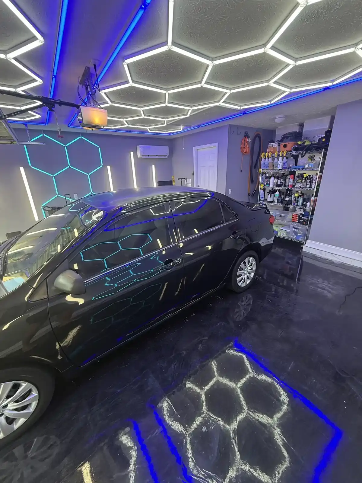 Black 2013 Toyota Corolla after a one-step paint correction under the hex shop lights in Panama City FL