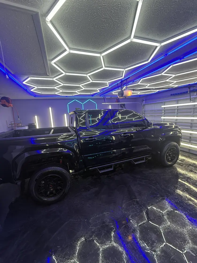 Black Toyota truck detailed and gleaming under the hex lights at Ceramico in Panama City FL