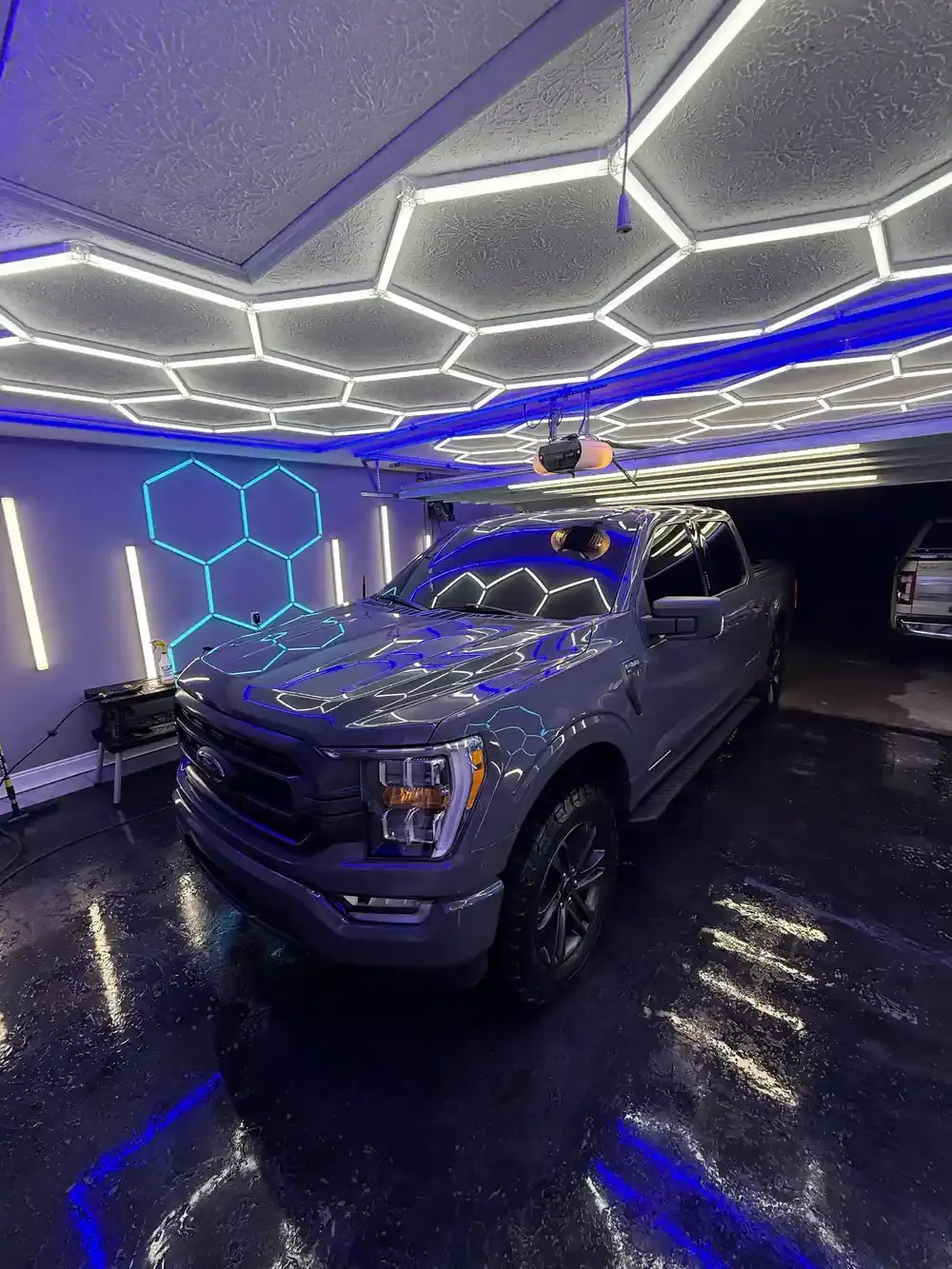 Grey 2021 Ford F-150 under the hex shop lights after a truck detail in Panama City FL