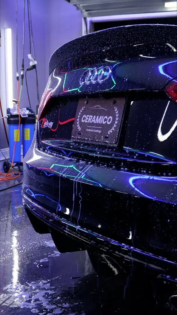 Audi RS rear with Ceramico license plate frame being prepped in garage under UV lights