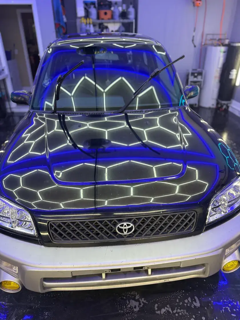 1996 Toyota RAV4 with a glossy hood reflecting the hex lights after a full detail at Ceramico in Panama City FL