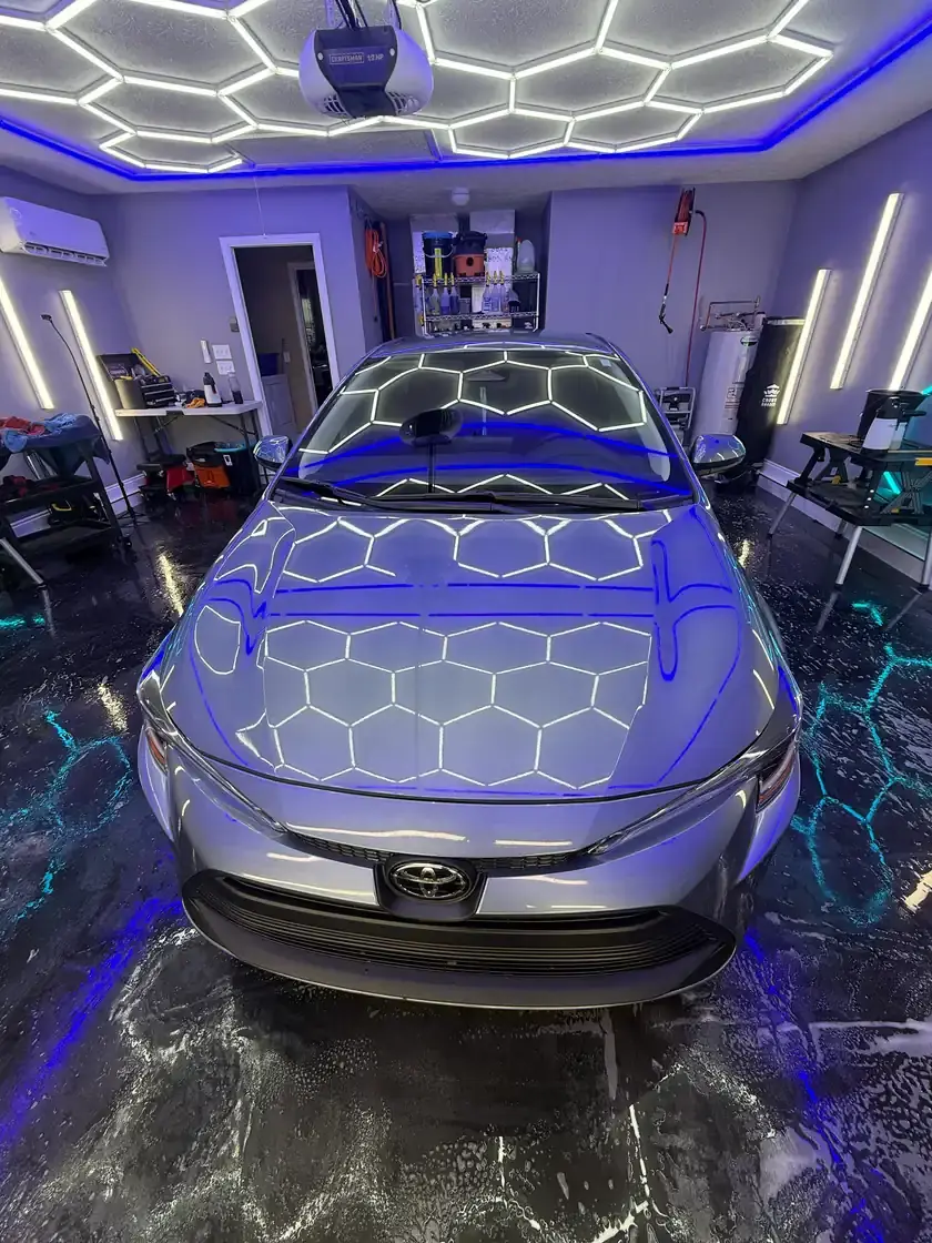Silver 2018 Toyota Corolla after a full interior and exterior detail under the hex lights at Ceramico in Panama City FL
