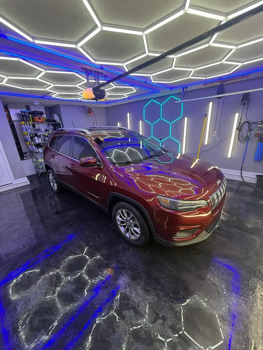 Dark red 2021 Jeep Cherokee after a full interior and exterior detail under the hex lights at Ceramico in Panama City FL