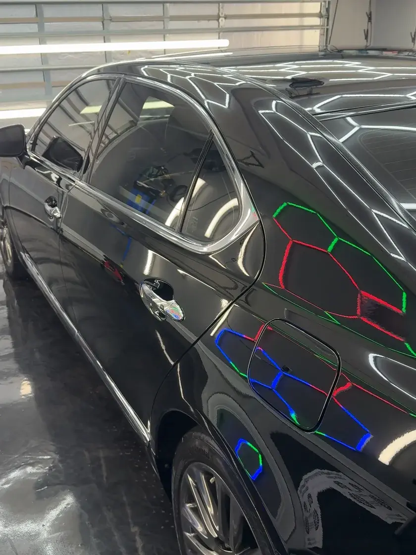 Black 2015 Lexus LS460 rear quarter panel reflecting the hex lights after paint correction and ceramic coating at Ceramico in Panama City FL