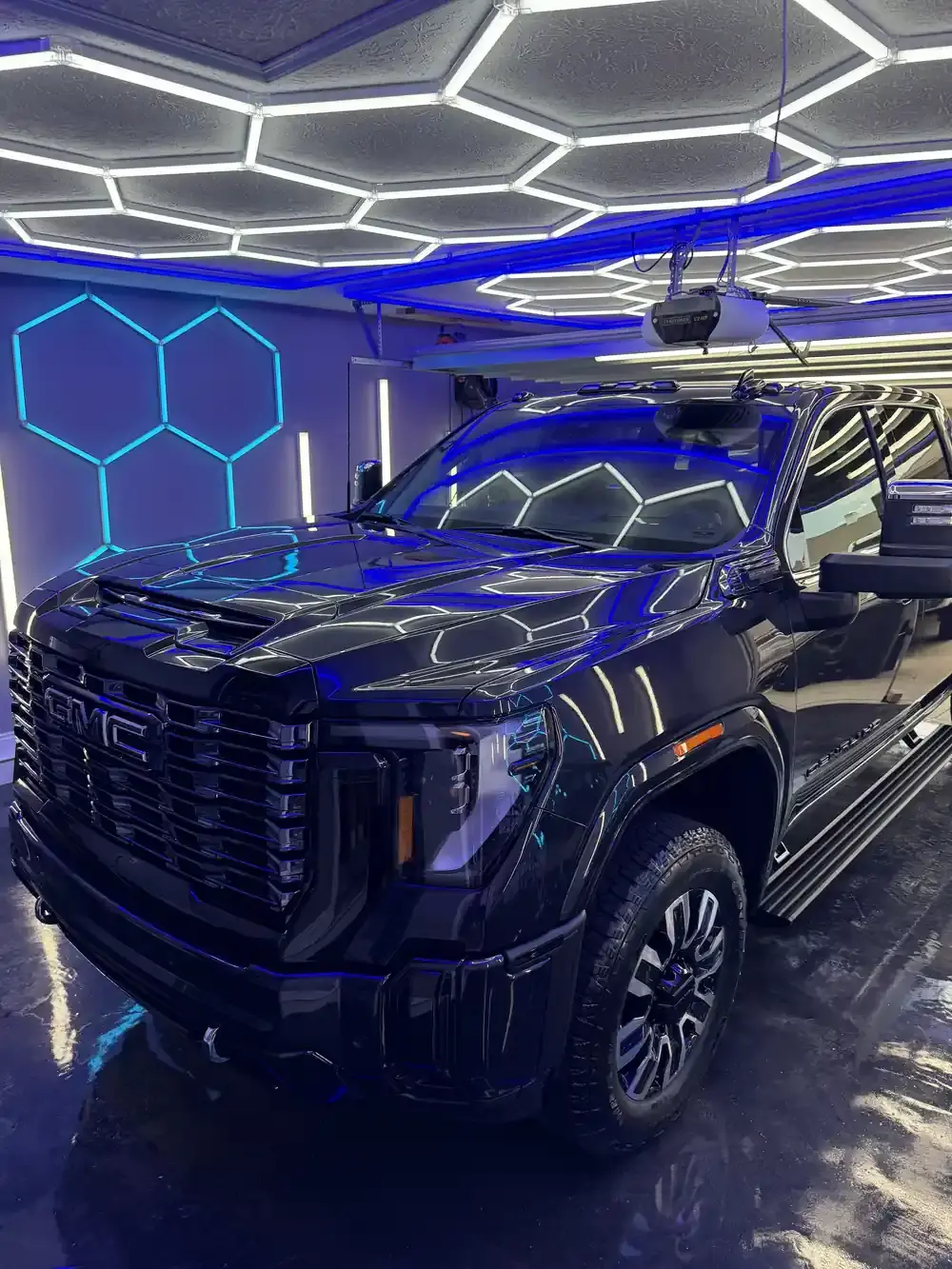 2026 GMC Denali 3500 under the hex shop lights after a ceramic coating in Panama City FL