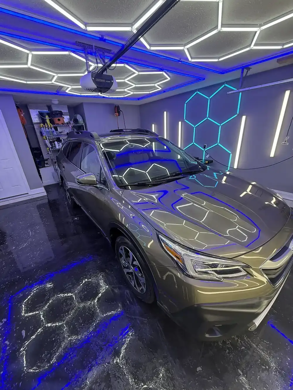 Green 2022 Subaru Outback reflecting the hex shop lights after a full detail in Panama City FL