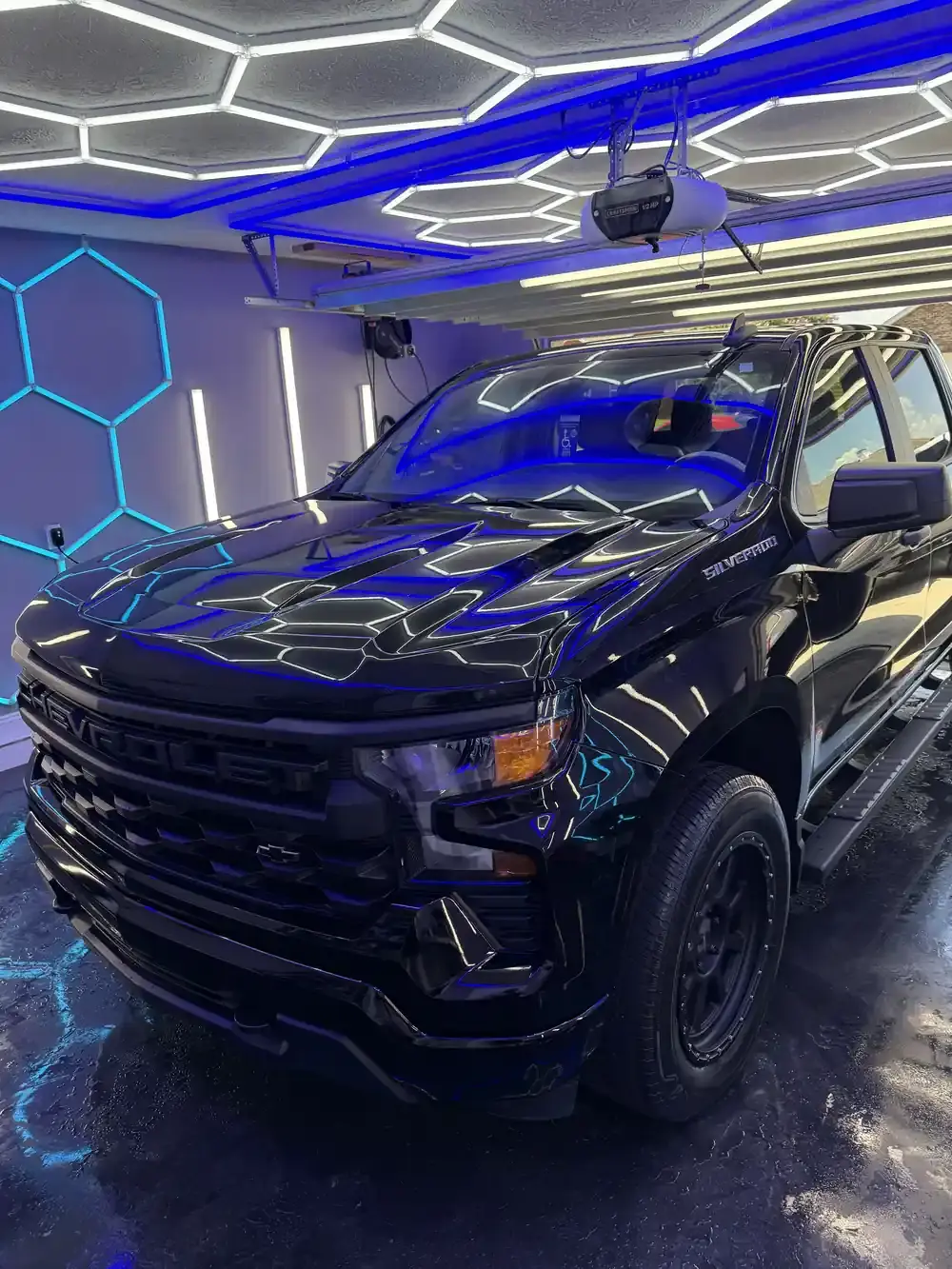 Black 2023 Chevy Silverado under the hex shop lights after a full detail in Panama City FL